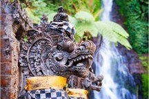 Dragon statues against the backdrop of Gitgit waterfall Dragon statues against the backdrop of Gitgit waterfall